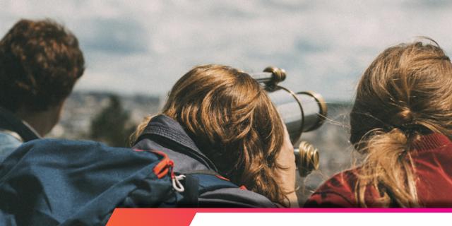 People watching through a telescope over the horizon